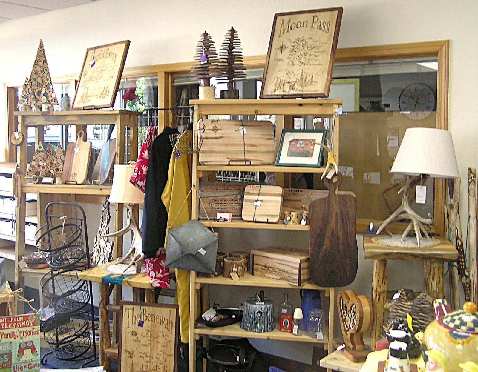 Hand-crafted wood signs, cutting boards and antler lamps in a vendor booth